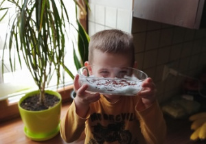 Chłopiec zasiał rzeżuchę - pokazuje jak rośnie w pojemniku