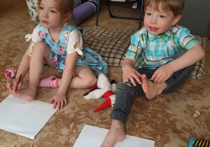 Rodzeństwo ćwiczy na dywanie