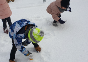 Dzieci zbierają snieg do eksperymentów