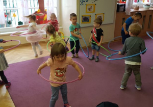 Dzieci próbują kręcić hula-hop 